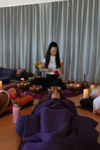 Angela Callahan holding a Group Sound Bath