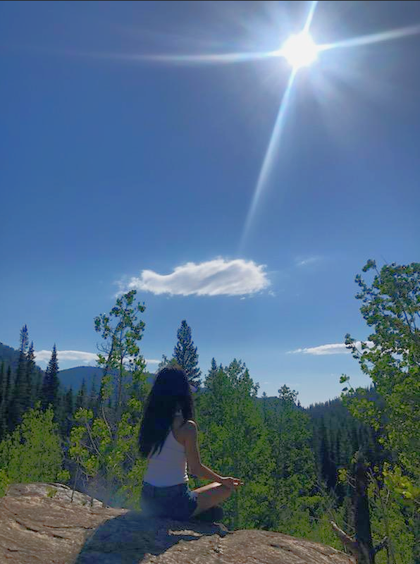 Angela Meditating on a mountain side